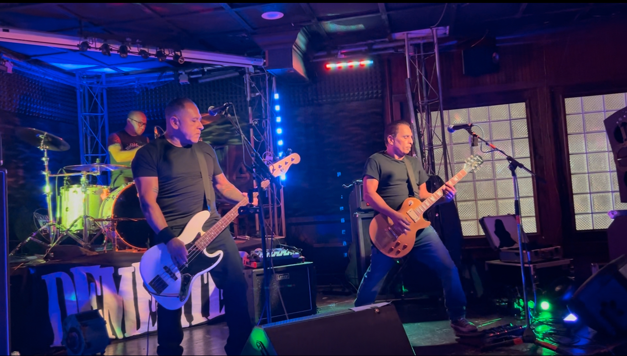 Dementers live at Fuel Bar in San Antonio, 2025: bass, guitar and drums under blue stage lights